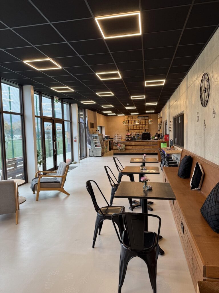 Bright interior of Brown Bag Sports Cafe at Sandylands with big windows onto the sports pitches